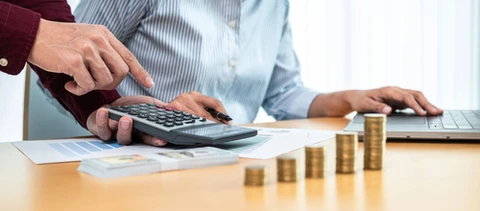 Scène d'intérieur professionnel avec deux personnes travaillant sur des documents financiers